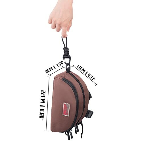 Hand holding a compact brown travel bag with dimensions displayed.