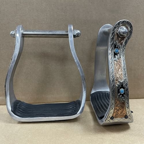 Pair of decorative metal stirrups with intricate designs