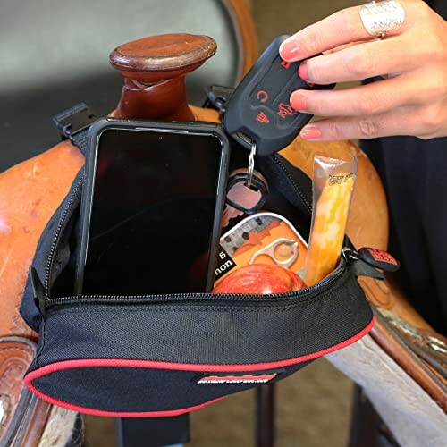 Saddlebag with phone, keys, snack, and apple.